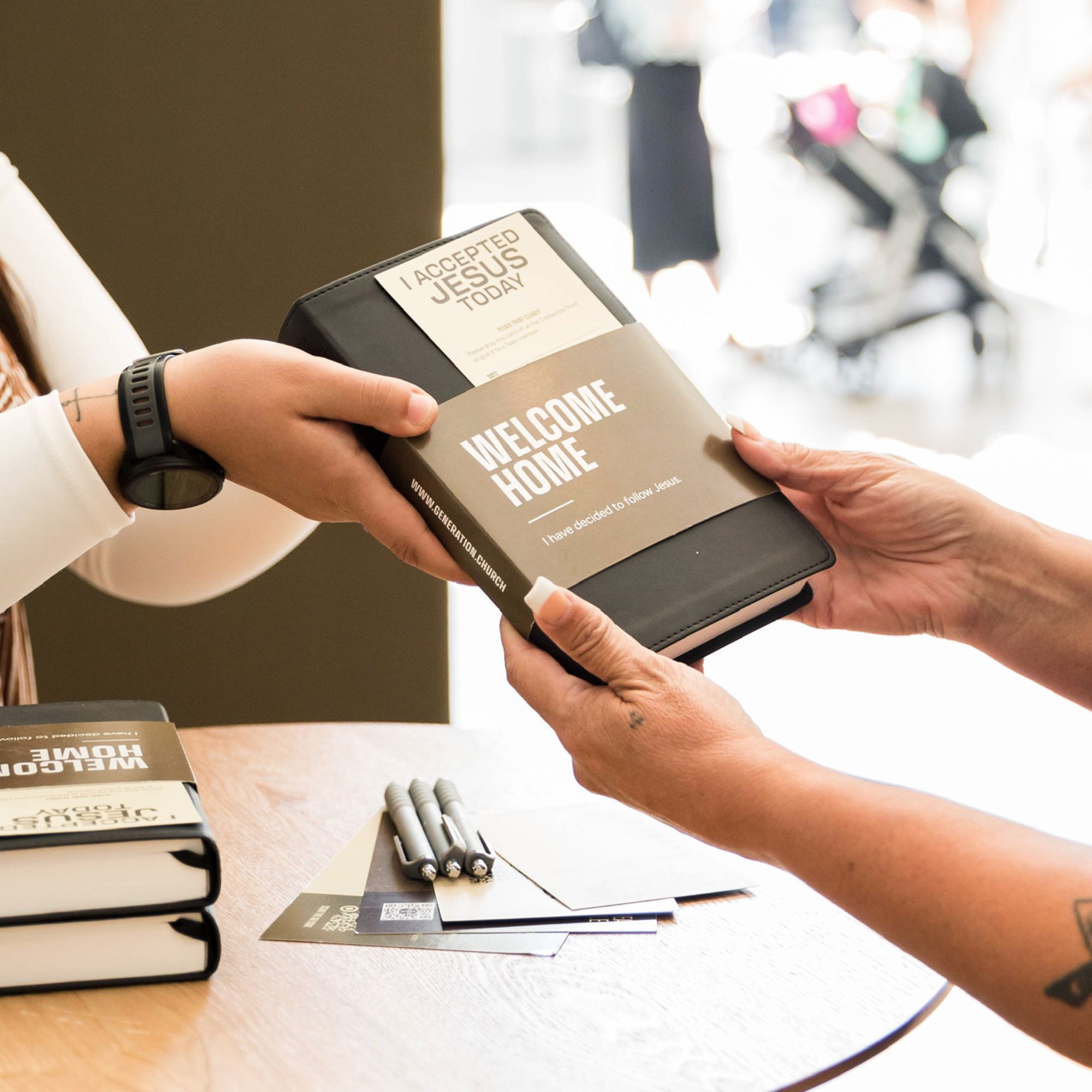 A person handing a book to another person
